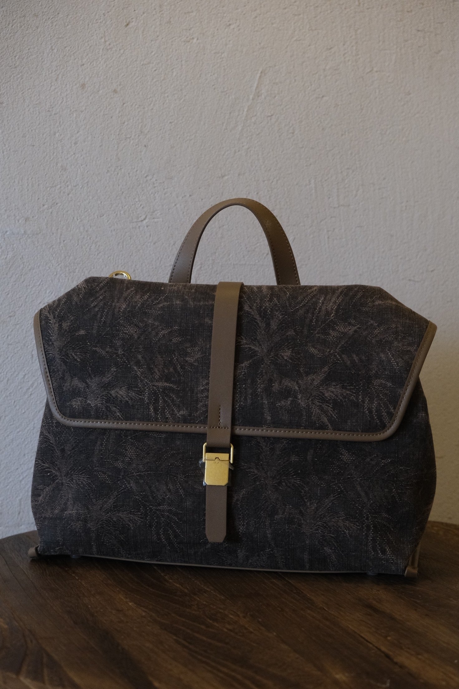 Luxury genuine leather edge details of handcrafted silk handbag