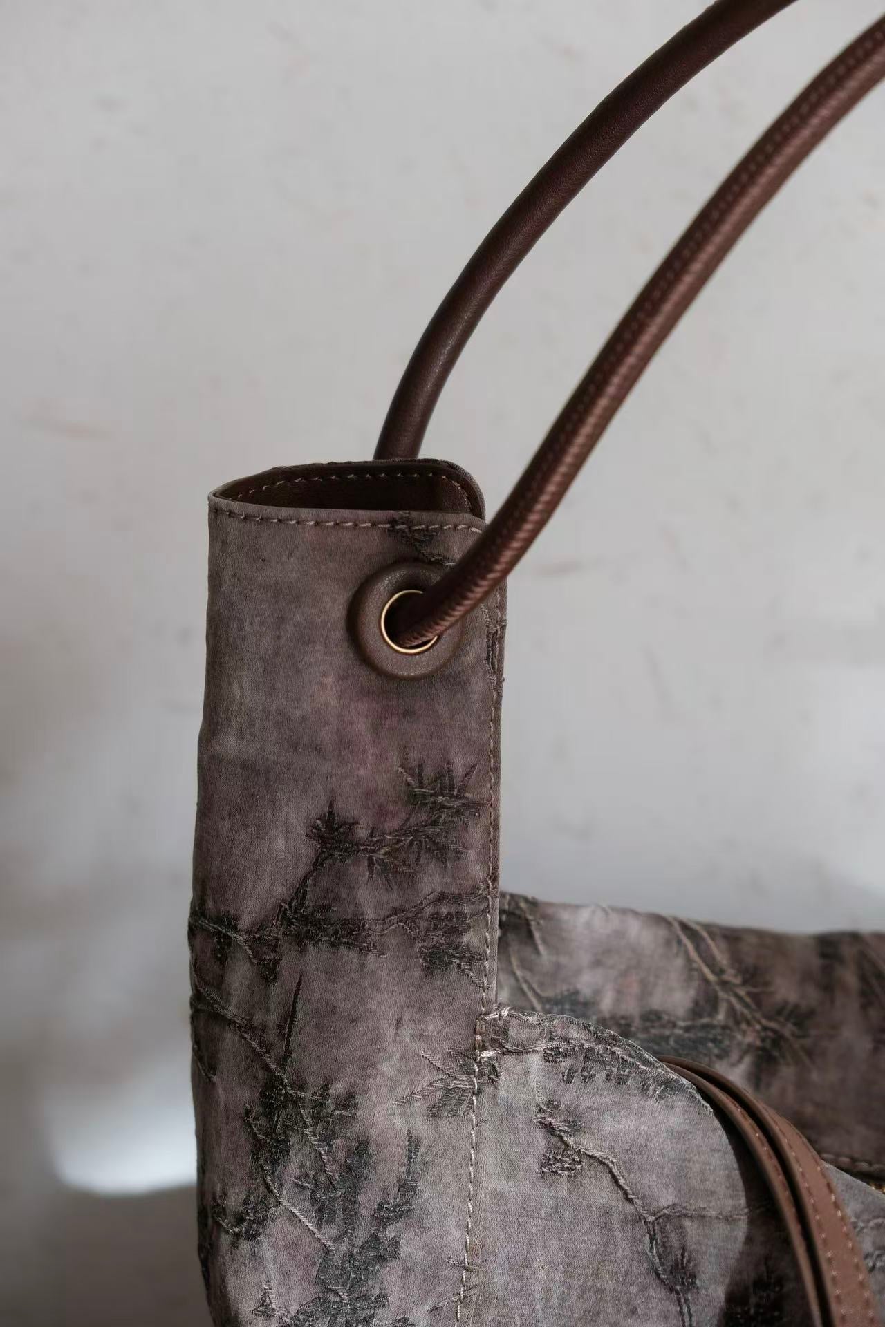 Handcrafted Xiangyunsha silk leather handbag inspired by Chinese heritage craftsmanship