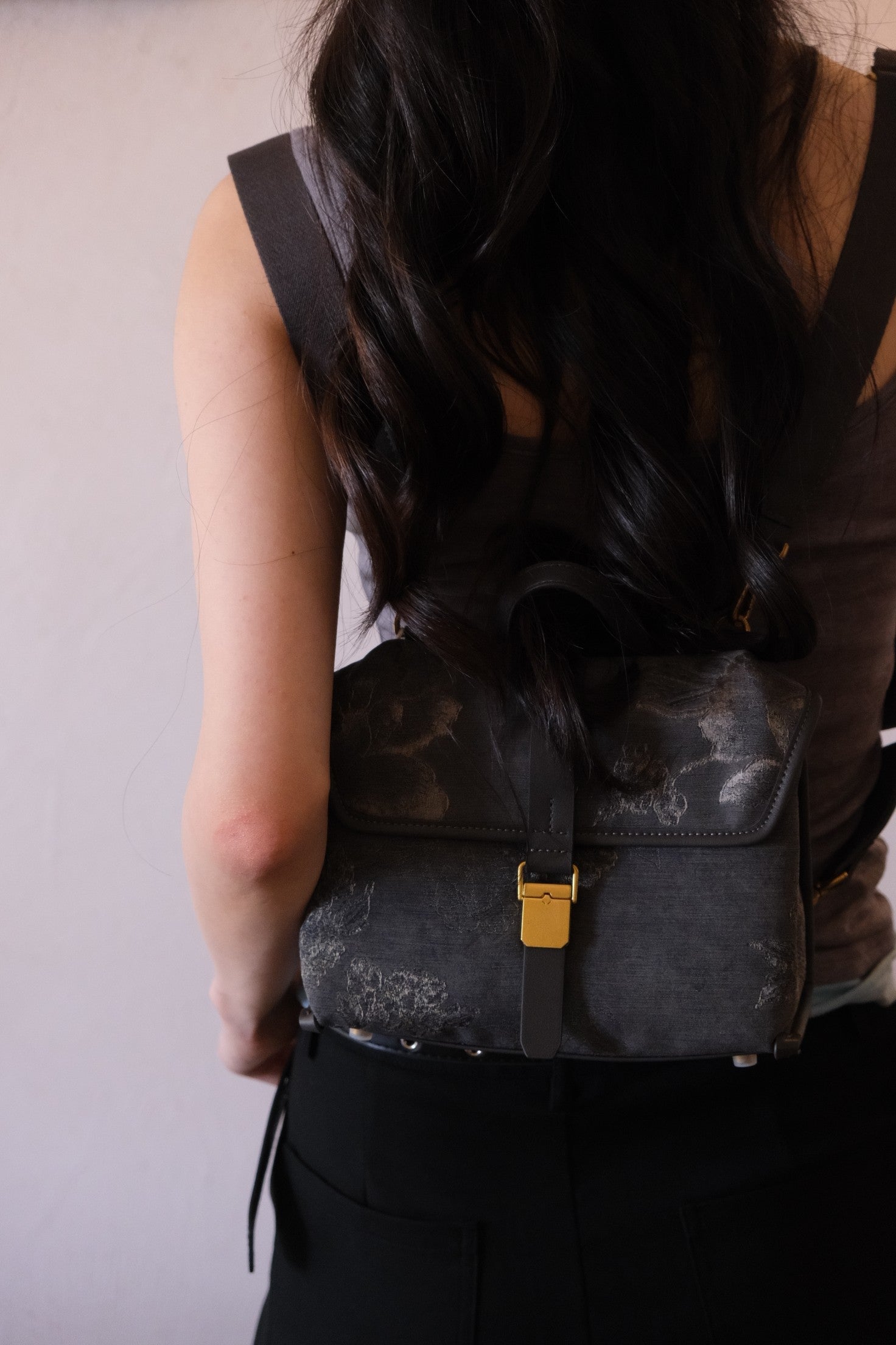 	Wide detachable fabric shoulder strap hardware close‑up
