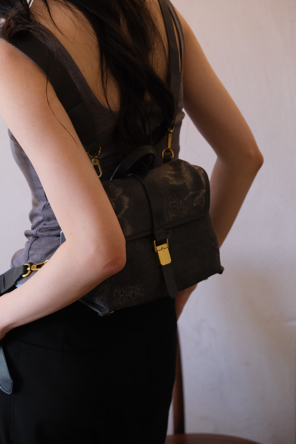 Model wearing as mini backpack, convertible mode styling shot